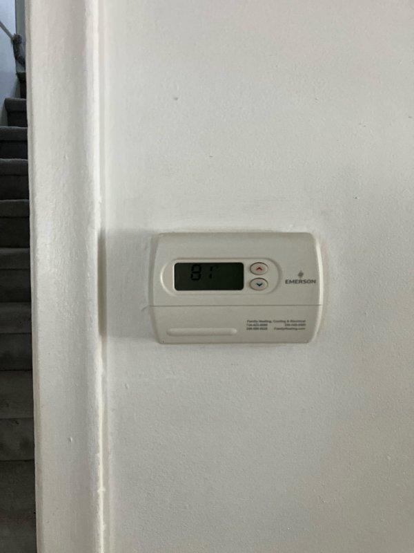 Conducted on-site assessment for adding air conditioning system to existing 3-year-old furnace installation in basement. Evaluated current HVAC infrastructure, electrical service capacity at meter location, and thermostat compatibility for future AC integration. Documented existing Emerson thermostat and exterior electrical service configuration to determine equipment requirements and installation specifications for complete cooling system addition.