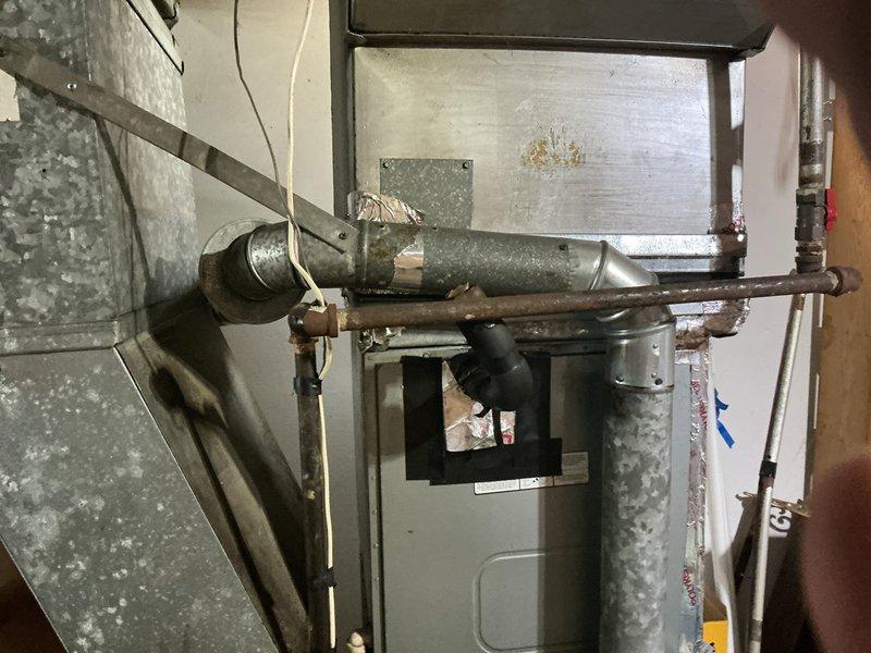 Installed chimney liner on 15-year-old chimney system located at right-hand side in back of building to address reported condensation issues occurring during winter months. System was verified to be maintaining proper heating function despite moisture accumulation. Liner installation completed to improve draft efficiency and prevent further condensation buildup within the chimney structure.