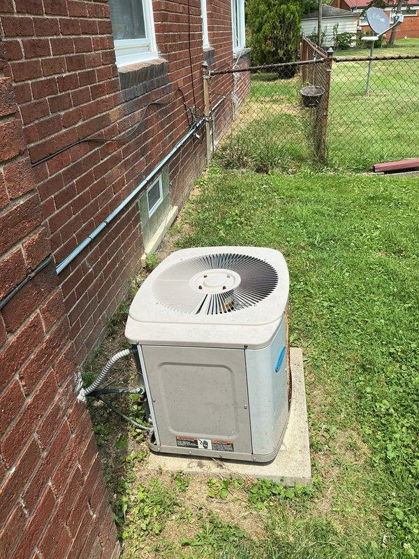Responded to service call for non-operational air conditioning system, approximately 6 years old, with equipment located in basement. Performed comprehensive assessment of Carrier brand outdoor condensing unit positioned on concrete pad against building exterior. Evaluated complete system including electrical disconnect, refrigerant lines, and conduit connections between outdoor unit and interior components. Provided detailed estimate for complete HVAC system replacement due to failure of existing equipment to power on or operate.