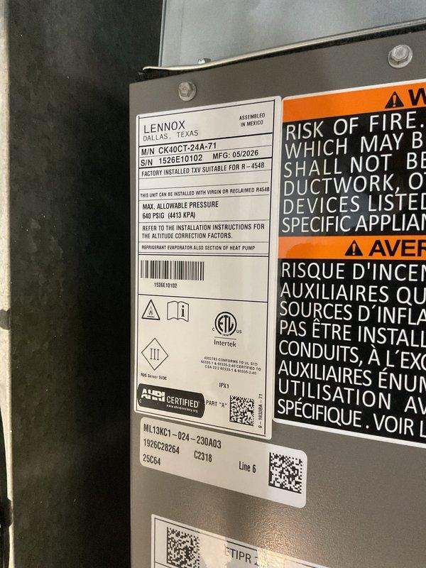 Successfully installed a 2-ton Lennox air conditioning condenser unit (Model CK40CT-24A-A71) with matching evaporator coil in residential basement location. Unit was positioned at rear of property and connected to existing furnace system with new plenum modifications to accommodate coil installation. Mechanical and electrical permits were obtained prior to installation, with electrical reconnection scheduled for licensed electrician to complete final power connection to 208-230V/1/60 service.