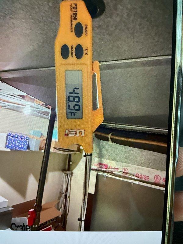 Responded to no cooling complaint affecting multiple upstairs zones while downstairs and one upstairs room maintained proper cooling. Performed system diagnostics on 3-year-old air conditioning unit located outside. Measured supply air temperature at affected zone register reading 48.8°F, confirming inadequate airflow or ductwork balancing issue rather than refrigeration system failure. Inspected upstairs distribution system including registers and ductwork accessibility. Identified airflow restriction or damper positioning affecting bathroom, hallway, and bedroom zones while leaving other areas unaffected. Documented temperature readings and system conditions with photographic evidence for reference.