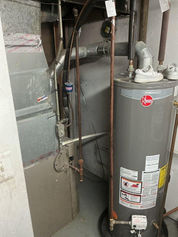 Responded to service call for 6-year-old residential air conditioning system experiencing reduced cooling capacity. Upon arrival, conducted comprehensive system evaluation including visual inspection of outdoor condenser unit located at rear of property and indoor air handler components. Performed standard diagnostic procedures to assess refrigerant levels, airflow, electrical connections, and overall system performance. Verified system operation and documented equipment condition through photographic records of indoor HVAC installation, including Carrier furnace unit and associated ductwork in basement utility area. System evaluated for common issues affecting cooling efficiency in units under 10 years old, including potential refrigerant concerns, airflow restrictions, and component wear.