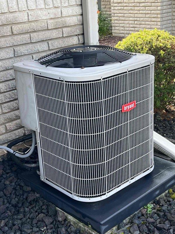 Completed comprehensive Gold AC inspection on 13-year-old residential air conditioning system with basement-located air handler. Performed non-invasive refrigerant diagnostics on R410A system, verifying proper operating pressures and temperatures with return air at 69.9°F dry bulb/59.2°F wet bulb and supply air at 49.4°F dry bulb/46.1°F wet bulb, indicating adequate system performance and cooling capacity. Inspected outdoor condenser unit, confirming clean exterior cabinet, proper installation on equipment pad, adequate clearances, and overall satisfactory condition with no visible defects or maintenance concerns identified.