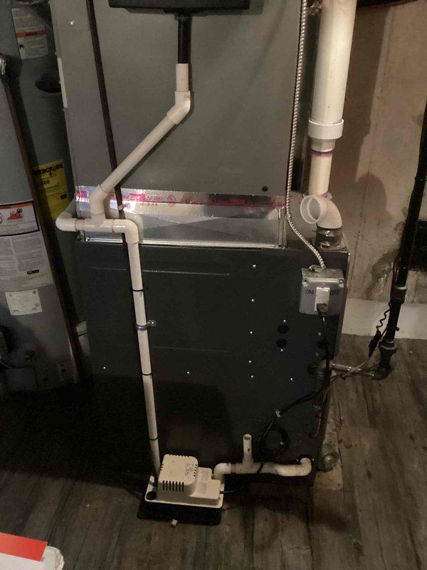 Responded to service call for non-operational air conditioning system over 20 years old located in basement. Performed comprehensive assessment of existing HVAC equipment and electrical infrastructure, including inspection of furnace, condensate drainage system, and main electrical panel with circuit breakers. Documented current equipment configuration and provided estimate for complete AC system replacement due to age and failure of existing unit.