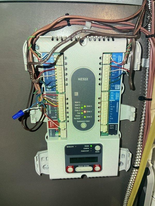 Completed repair of HVAC zoning system by replacing defective zone damper in basement air conditioning system. Installed new zone damper in ductwork and verified proper operation of HZ322 zone control panel with all three zones functioning correctly. System tested and confirmed operational with all zone indicators illuminated and damper responding appropriately to zone calls.