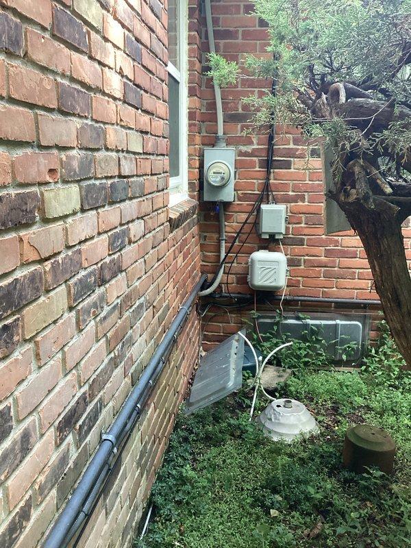 Conducted on-site evaluation of existing residential standby generator for replacement estimate. Unit exhibited significant weathering, surface corrosion, and deterioration from prolonged outdoor exposure. Documented generator condition, location constraints in side yard utility area, existing electrical service configuration including meter base and disconnect boxes, and conduit routing. Photographed equipment positioning relative to HVAC system and assessed accessibility for future installation. Provided comprehensive assessment for generator replacement specifications and electrical service requirements.