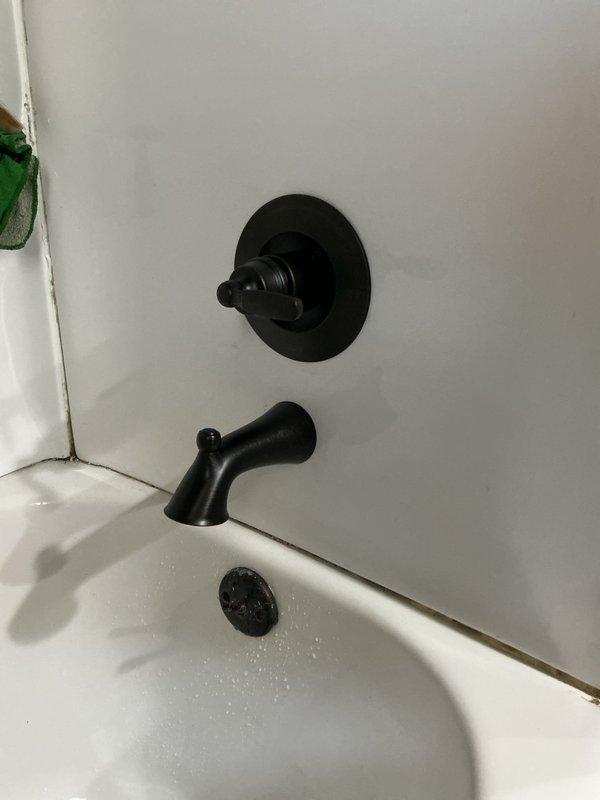Picked up replacement parts from Ferguson supply house and successfully installed a new Delta shower valve assembly. The installation included mounting the valve control, tub spout, and shower head with coordinating black matte finish fixtures. All components were properly secured to the tiled shower walls and tested for proper water flow and temperature control functionality.