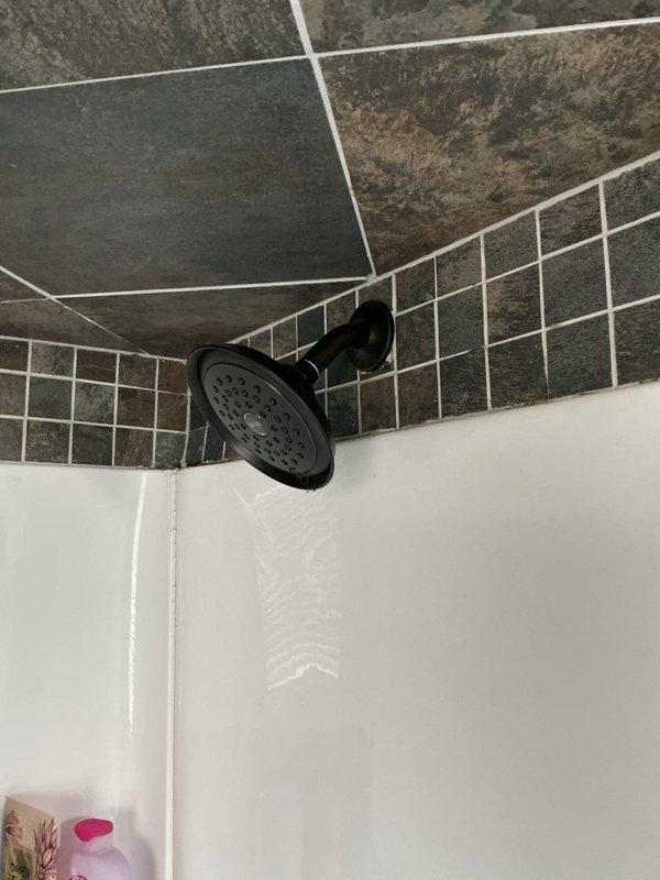Picked up replacement parts from Ferguson supply house and successfully installed a new Delta shower valve assembly. The installation included mounting the valve control, tub spout, and shower head with coordinating black matte finish fixtures. All components were properly secured to the tiled shower walls and tested for proper water flow and temperature control functionality.