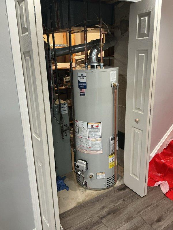 Installed a 50-gallon Bradford White tanked water heater in utility closet. Connected copper supply lines, installed PVC venting with proper elbow configuration, and reconnected all plumbing fixtures. Verified proper operation, checked for leaks, and ensured all manufacturer specifications and safety labels were visible and compliant.