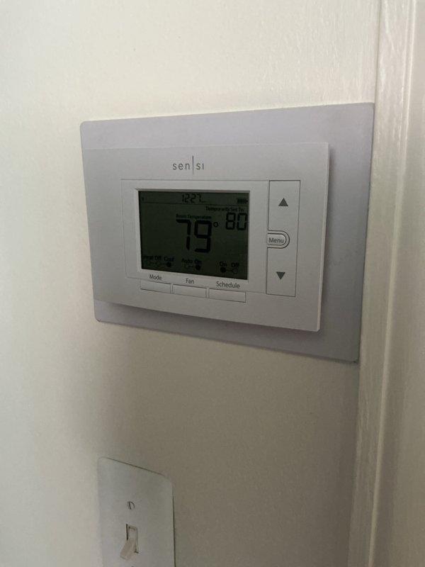 Completed Gold AC Inspection on a 3-year-old residential HVAC system with air handler and furnace located in basement. Verified system operational status, inspected air handler unit with connected ductwork, examined PVC condensate drainage lines, checked furnace components and auxiliary condensate pump with associated piping connections, and confirmed thermostat functionality showing proper temperature control in heating mode at 79°F.