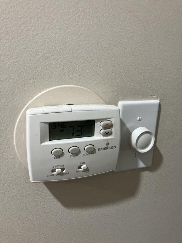 Performed GOLD AC inspection on 3-year-old Goodman air conditioning system with filter change service. Evaluated outdoor condenser unit, indoor air handler located in basement, and Emerson programmable thermostat operation. System currently operational; provided estimate for replacement options due to R22 refrigerant phase-out concerns.