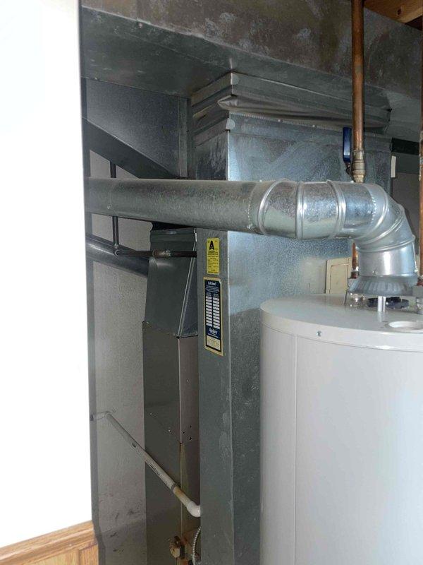 Responded to service call for cooling system not blowing cool air. Upon inspection, found 10+ year old HVAC system located in basement with furnace and associated ductwork showing age-related wear. Evaluated complete system including thermostat operation, furnace unit, ductwork configuration, and overall equipment condition. Provided comprehensive full system replacement estimate to address cooling deficiency and aging equipment concerns.