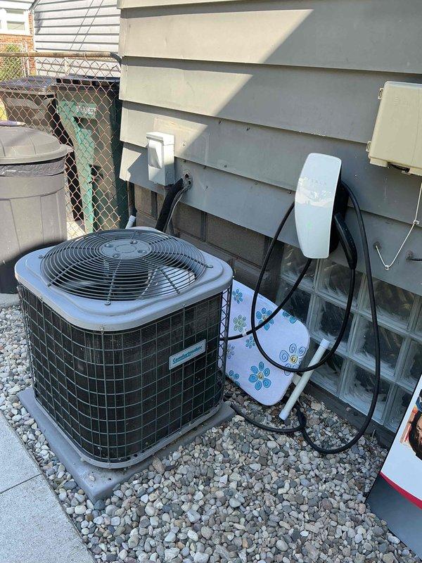 Completed comprehensive Gold AC Inspection and annual tune-up on residential cooling system. Inspected outdoor condenser unit (Model N4A324AKC100, R-410A refrigerant, 208-230V) located on concrete pad with proper gravel clearance. Verified all electrical connections at disconnect box and wall-mounted components, confirmed unit nameplate specifications and serial number documentation, cleaned condenser coil fins, checked refrigerant levels, tested capacitor performance, and verified proper fan motor operation. System operating within normal parameters with no deficiencies noted; unit shows appropriate weathering for age with all safety components functioning correctly.