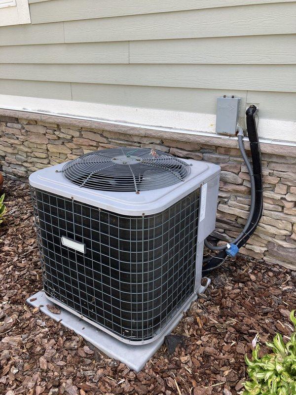 Provided comprehensive estimate for replacement of existing 3.5 ton residential air conditioning system with new 4 ton unit. Evaluated current outdoor condenser unit located on exterior side of home, mounted on concrete pad against house foundation with refrigerant lines and electrical conduit running up exterior wall to indoor air handler. Documented existing equipment configuration including placement, electrical disconnect, line set routing, and clearances for proper sizing and installation planning of replacement system.