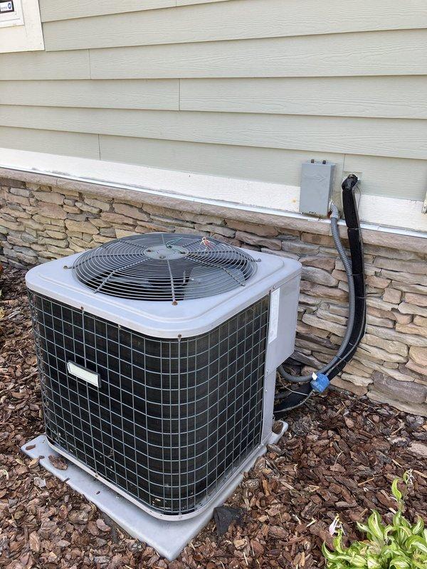 Provided comprehensive estimate for replacement of existing 3.5 ton residential air conditioning system with new 4 ton unit. Evaluated current outdoor condenser unit located on exterior side of home, mounted on concrete pad against house foundation with refrigerant lines and electrical conduit running up exterior wall to indoor air handler. Documented existing equipment configuration including placement, electrical disconnect, line set routing, and clearances for proper sizing and installation planning of replacement system.