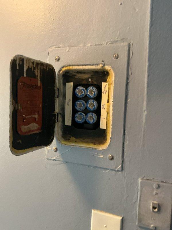 Performed comprehensive electrical system assessment of residential property with original fuse panel and wiring. Evaluated existing six-fuse panel configuration and determined inadequate amperage capacity for air conditioning unit, which was experiencing circuit overload issues on 15-amp fused circuit. Inspected grounded outlet system and aging electrical infrastructure including multiple junction boxes and conduit runs showing signs of environmental exposure and deterioration. Provided detailed estimate for complete electrical service upgrade including replacement of obsolete fuse panel with modern circuit breaker panel and installation of dedicated 240-volt circuit with appropriate amperage capacity and exterior outlet for air conditioning unit to meet current electrical code requirements and equipment specifications.