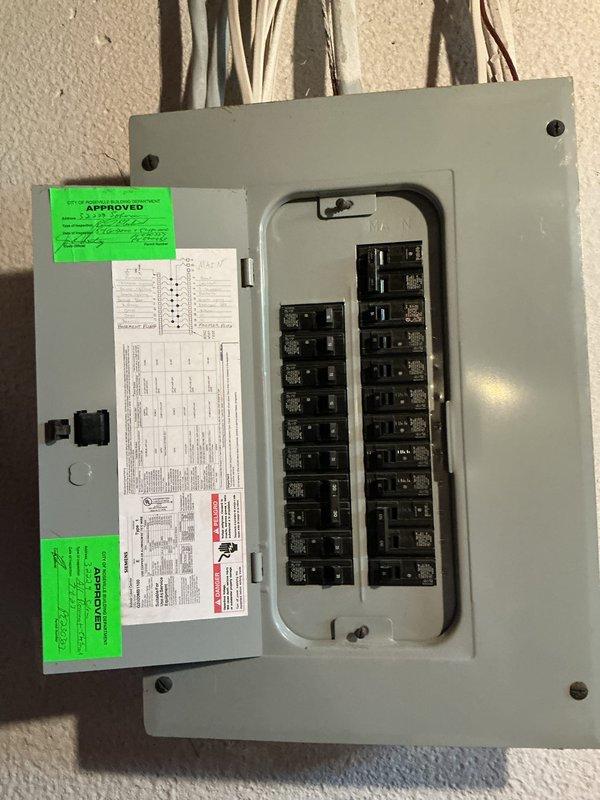 Conducted on-site evaluation for whole home generator installation at residential property. Assessed existing electrical panel configuration and capacity to determine compatibility with generator system requirements. Documented current electrical infrastructure including main service panel with dual-column breaker arrangement and exterior conditions near proposed installation area adjacent to building exterior wall and downspout location.