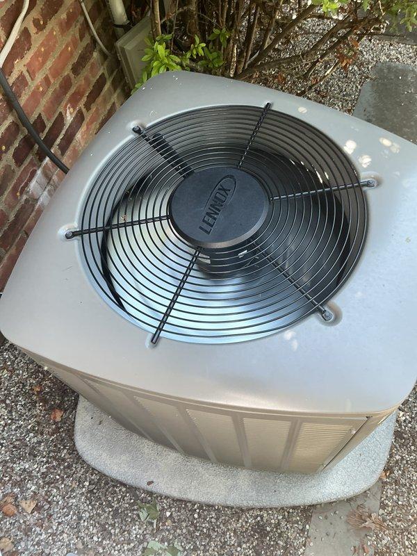 Completed comprehensive Gold AC inspection on three-unit residential HVAC system with 2-year-old equipment. Inspected Lennox outdoor condenser units positioned on proper mounting pads with adequate clearance, verified fan assemblies and protective guards were intact and operational, and confirmed all equipment was functioning properly. Documented system condition with photography showing units in good operational status with normal weathering appropriate for outdoor installation.