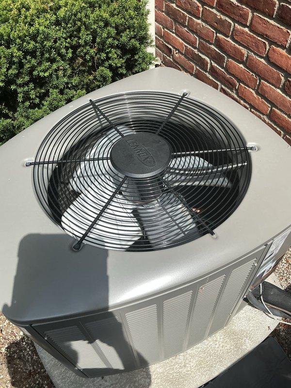Completed comprehensive Gold AC inspection on three-unit residential HVAC system with 2-year-old equipment. Inspected Lennox outdoor condenser units positioned on proper mounting pads with adequate clearance, verified fan assemblies and protective guards were intact and operational, and confirmed all equipment was functioning properly. Documented system condition with photography showing units in good operational status with normal weathering appropriate for outdoor installation.