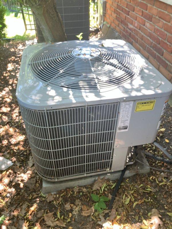 Completed estimate for replacement of 5-year-old residential air conditioning system with outdoor condensing unit currently located against brick exterior wall in landscaped area. Assessed existing equipment condition, verified electrical connections and concrete pad placement, documented current installation configuration including proximity to building structure and surrounding vegetation. Provided comprehensive replacement options and specifications for new HVAC system to meet homeowner's cooling requirements.