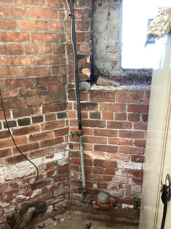Conducted on-site evaluation for new whole home generator installation at a residential property with basement mechanical space. Assessed existing electrical infrastructure, including aged electrical conduit routing along exposed brick walls and available space for generator equipment placement. Documented current conditions of utility area featuring HVAC ductwork and concrete flooring to determine optimal installation location, load requirements, and necessary electrical service upgrades for whole home generator system integration.