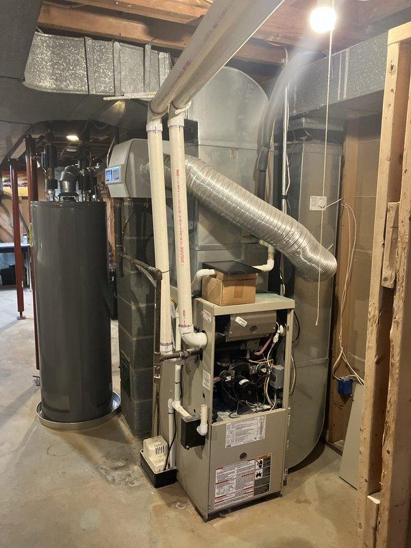 Conducted comprehensive assessment of aging residential HVAC system for full replacement estimate. Existing furnace and air conditioning units located in basement mechanical room have reached end of serviceable life and require replacement. Documented current system configuration including thermostat, furnace unit, ductwork connections, and overall installation layout to provide accurate replacement specifications and ensure proper sizing for new equipment installation.