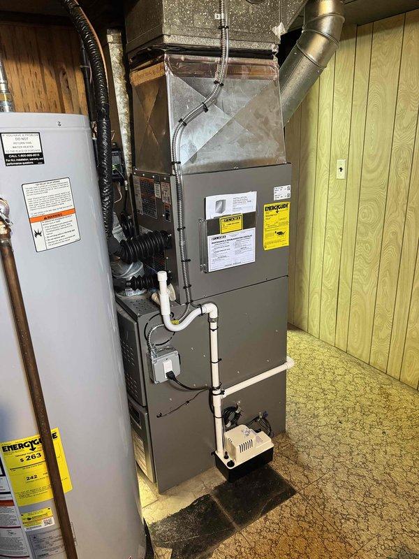 Completed installation of 2-ton air conditioning unit with matching evaporator coil in front-return configuration. Reconnected system to existing furnace and ductwork, installed condensate pump, and verified proper refrigerant charge and airflow. Mechanical permit obtained for HVAC components only, with electrical work to be completed by licensed electrician at later date.