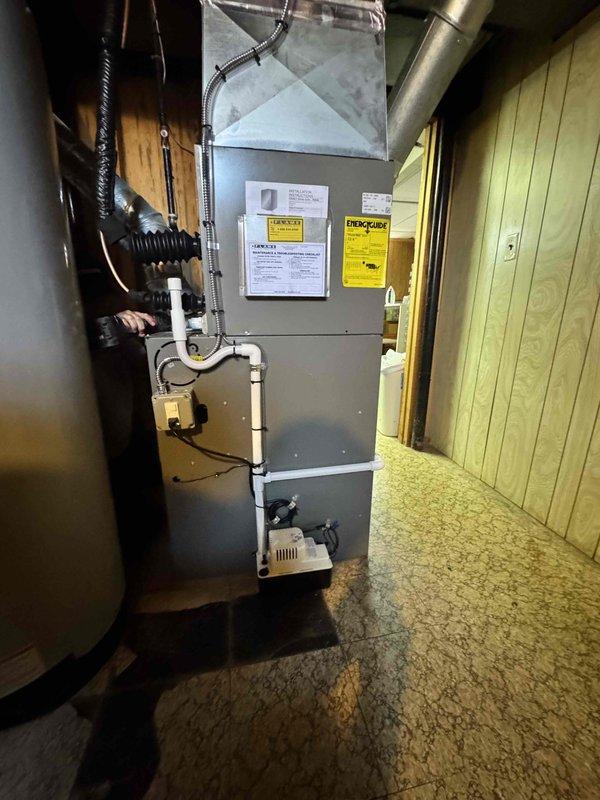 Completed installation of 2-ton air conditioning unit with matching evaporator coil in front-return configuration. Reconnected system to existing furnace and ductwork, installed condensate pump, and verified proper refrigerant charge and airflow. Mechanical permit obtained for HVAC components only, with electrical work to be completed by licensed electrician at later date.