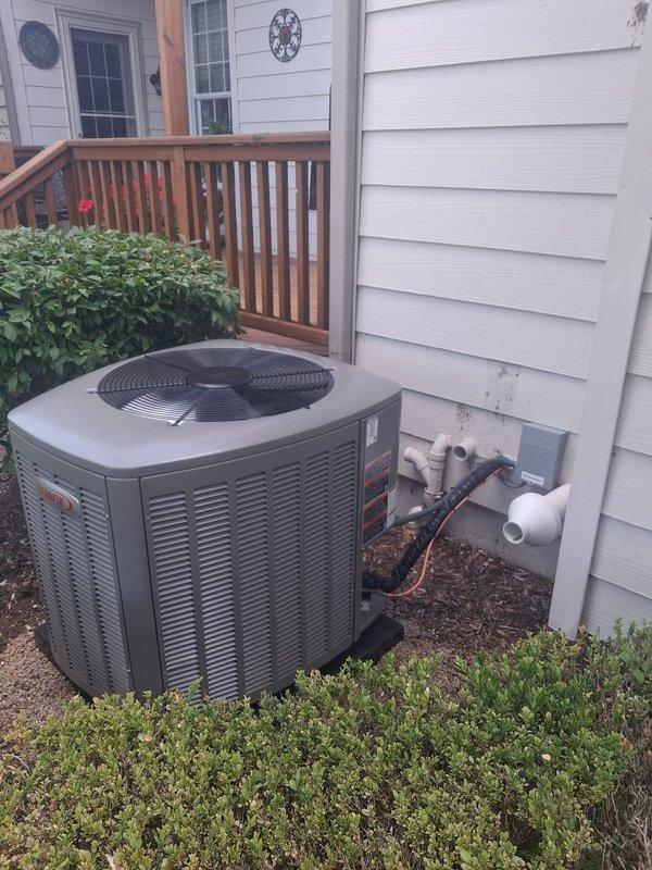 Completed full HVAC system installation including 70,000 BTU furnace and 2.5-ton air conditioning unit. Installed new thermostat, whole-home humidifier, and reconnected all electrical and refrigerant lines. Positioned outdoor condenser unit in rear yard with proper disconnect box and line set installation. Configured indoor furnace with metallic ductwork connections in basement mechanical room. Requested mechanical permit and registered system for utility rebate program with AHRI certificate number 215663829.