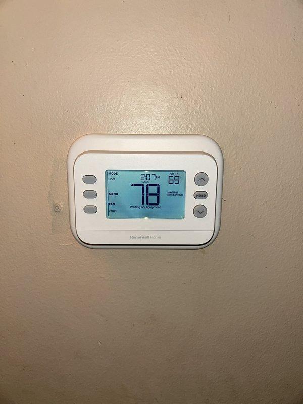 Completed full HVAC system installation including 45,000 BTU furnace, 1.5-ton air conditioning unit with rear discharge configuration, humidifier, and Honeywell Home programmable thermostat. Installed condensate drain piping on exterior wall with proper routing and secured all exterior components. Coordinated electrical reconnection requirements and obtained mechanical and electrical permits. System registered under AHRI certificate 215584603 for utility rebate qualification and verified all equipment operational upon completion.