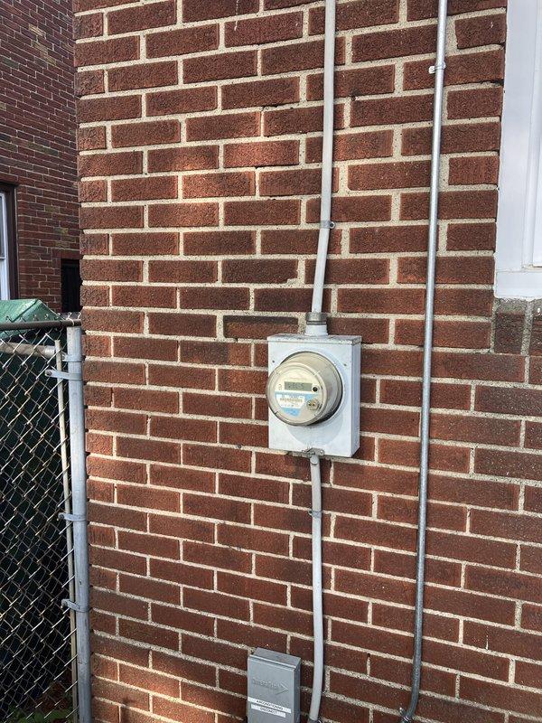 Responded to service call for cooling system concerns at residential property. Performed visual inspection of 10+ year old cooling equipment located in basement, which was found to be operational and producing cool air at time of visit. Documented electrical service panel and exterior meter installation with photographic records showing standard residential 120/240V distribution panel with properly labeled circuits and exterior utility metering equipment in serviceable condition.