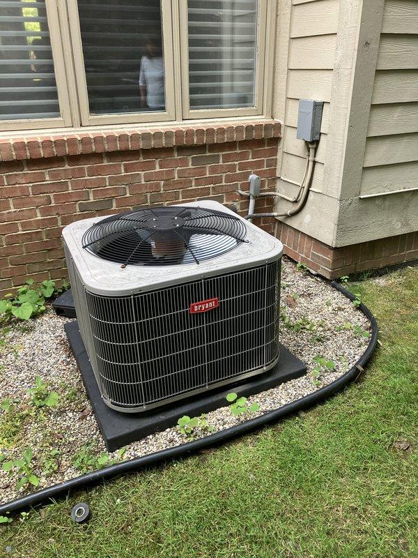 Completed comprehensive estimate for replacement of 10+ year old residential air conditioning system. Evaluated existing Bryant condensing unit located on exterior gravel pad with air handler and evaporator coil situated in basement. Documented current system configuration including electrical service, refrigerant line routing, and condenser placement on side of residence. Photographed existing equipment and installation area to assess replacement requirements. Advised property owner on importance of maintaining clear area around outdoor unit, free from debris and animal waste. Provided recommendations for complete AC system replacement due to age of equipment.