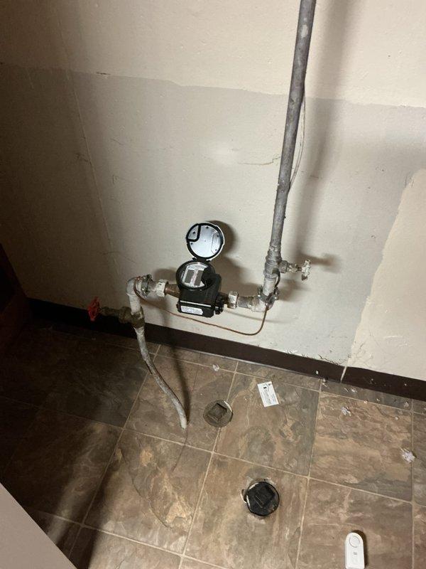 Completed installation of 40-gallon tanked water heater in basement utility area with proper copper piping connections and venting. Customer was advised that a drain pan is required per code compliance to prevent potential violations, and this item needs to be installed to meet current plumbing regulations.