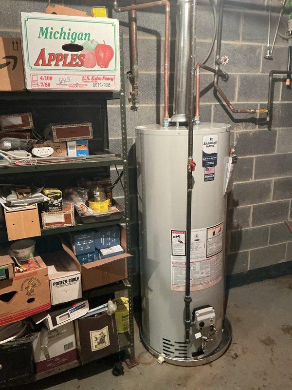 Completed installation of 50-gallon residential tank-type water heater in basement utility area. Connected copper supply lines, installed pressure relief valve with discharge piping, and mounted expansion tank to system. Verified all connections for proper operation and tested unit functionality upon completion.