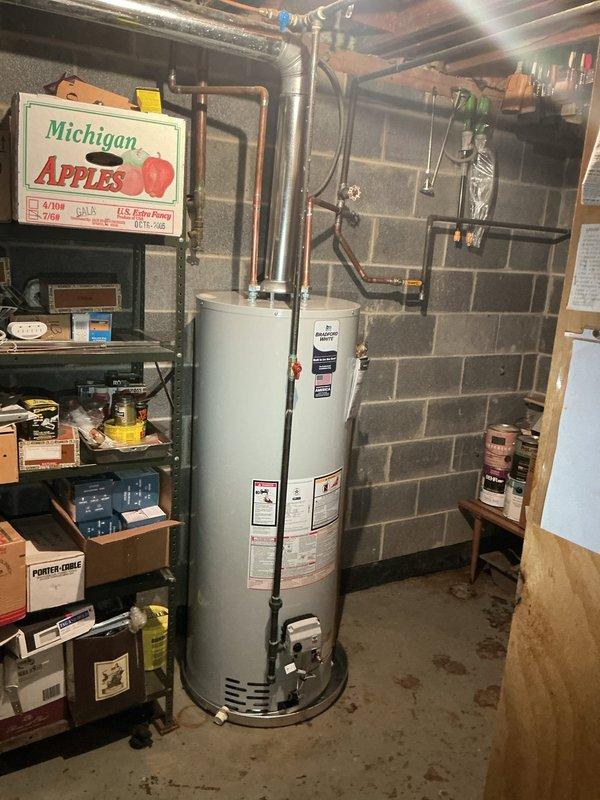 Completed installation of 50-gallon residential tank-type water heater in basement utility area. Connected copper supply lines, installed pressure relief valve with discharge piping, and mounted expansion tank to system. Verified all connections for proper operation and tested unit functionality upon completion.