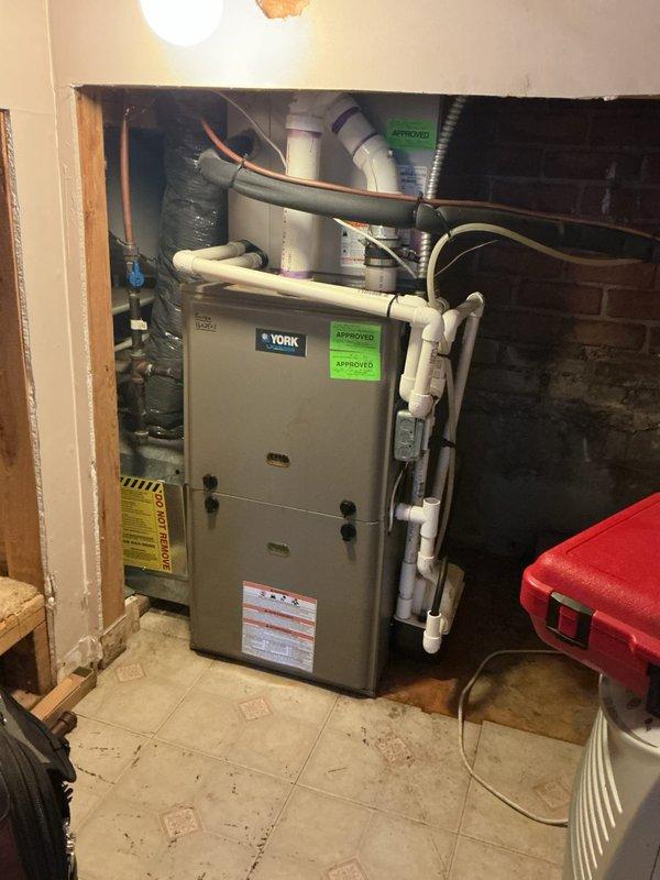 Performed routine maintenance on two furnaces and two air conditioning units. Conducted comprehensive tune-up on York furnace located in basement, including combustion analysis which revealed CO2 levels at 6.2%, O2 at 9.98%, and efficiency at 93.7% on natural gas system. Inspected and tested all major components including heat exchanger, burners, blower assembly, and venting system. Checked refrigerant lines, condensate drain lines, and all PVC venting connections for proper operation. Performed visual inspection of second furnace in garage and both outdoor AC units. Identified failed blower motor and inducer motor requiring replacement; parts ordered under PO 1340748-001 for installation upon arrival. All systems operational at time of inspection with no immediate safety concerns. Applied approval stickers to completed maintenance items. Return visit scheduled for motor replacement and final system verification.