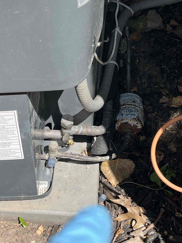Responded to no-cool call on 7-year-old residential AC system affecting entire home. Upon arrival, performed comprehensive diagnostic inspection of outdoor condensing unit. Visual examination revealed signs of weathering and component wear consistent with age. Inspected electrical connections, compressor assembly, and refrigerant lines for proper operation. Documented current system condition with photographic evidence showing outdoor unit components, including condenser coil, compressor housing, and associated wiring. Examined ductwork connections and noted discoloration on insulation near metal collar, indicating possible historical moisture exposure. Verified unit accessibility and assessed overall system performance to determine root cause of cooling failure.