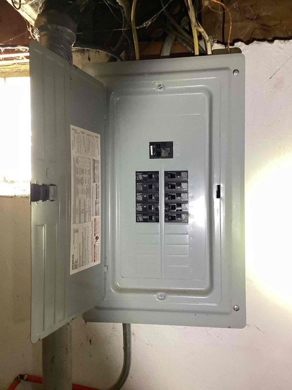 Completed full system estimate for 15-year-old HVAC system experiencing condensation issues in chimney during winter operation. Assessed existing chimney liner condition at rear right-hand side of building and documented current system functionality, noting heating capability remains intact despite moisture accumulation. Evaluated electrical panel, thermostat controls, and overall system configuration to provide comprehensive replacement recommendations addressing condensation concerns and aging equipment.