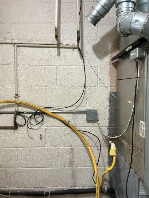 Removed existing wall-mounted tankless water heater unit and successfully installed a new 40-gallon standard tank water heater in the utility room. Disconnected and capped PVC exhaust venting system that was previously required for tankless operation. Reconnected existing copper water supply lines, gas line, and electrical connections to new tank unit per manufacturer specifications and local code requirements.