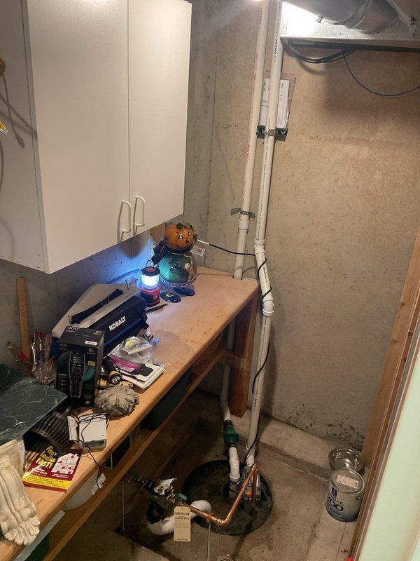 Installed water-powered backup sump pump system in basement utility area. Connected unit to existing plumbing infrastructure using PVC and copper piping with appropriate valves and fittings to ensure automatic activation during primary pump failure or power outage.
