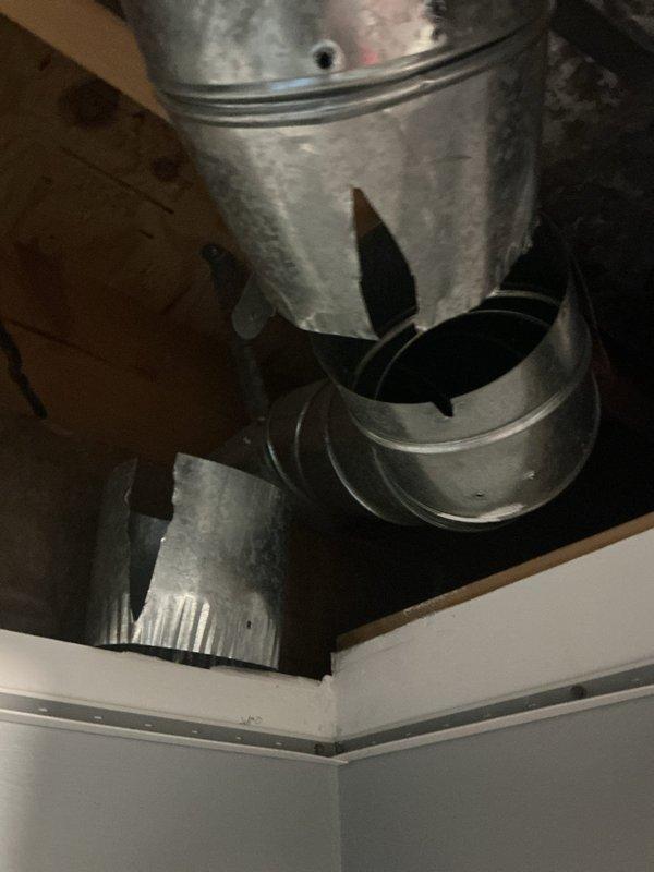 Responded to service call for a nearly new air conditioning system experiencing issues with zone damper operation. Upon inspection, identified two failed Belimo damper actuator motors in the basement ductwork. System was still providing partial cooling despite the malfunctioning dampers. Documented the damaged components with photos showing the damper actuators mounted on the galvanized ductwork and Y-junction assembly. Ordered replacement damper motors for installation upon arrival at shop. Customer able to continue operation with reduced zoning capability until parts become available for completion of repairs.