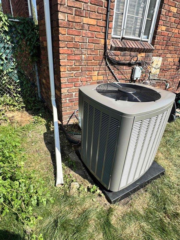 Completed installation of 3-ton Lennox air conditioning condenser unit with matching evaporator coil at rear of residence. Unit was positioned on concrete pad against brick exterior wall, with electrical disconnect box mounted and conduit properly run for power connection. All mechanical and electrical permits were requested and reconnection of existing electrical service was completed to manufacturer specifications.