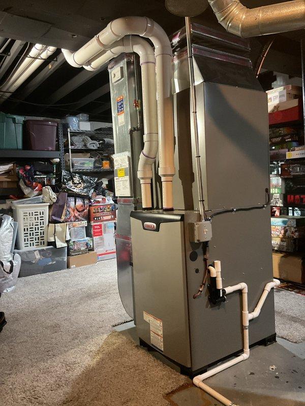 Completed full HVAC system installation including a 90,000 BTU high-efficiency furnace, 3-ton air conditioning unit with rear discharge configuration, and whole-home humidifier in basement mechanical room. Installed all required PVC venting and drainage piping, connected ductwork, performed electrical reconnection, and verified proper system operation. Mechanical permit obtained and utility rebate applications submitted for energy-efficient equipment upgrade.