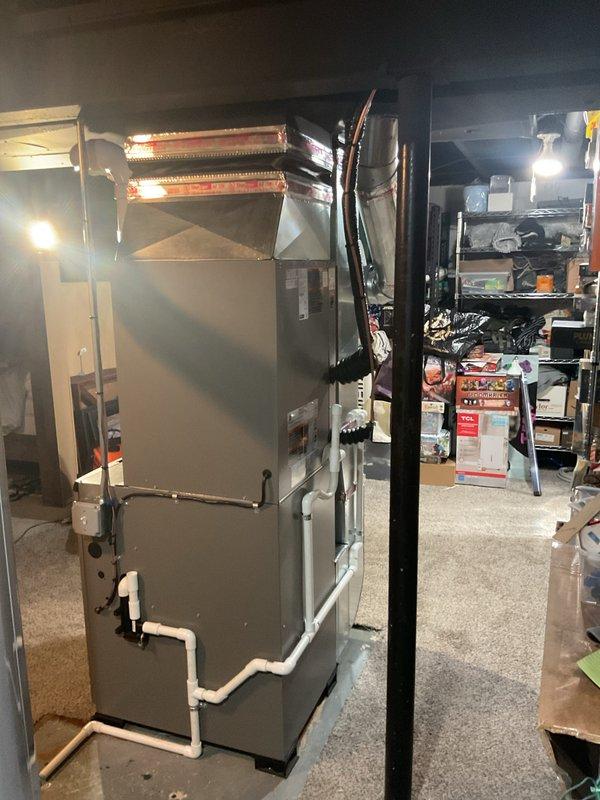 Completed full HVAC system installation including a 90,000 BTU high-efficiency furnace, 3-ton air conditioning unit with rear discharge configuration, and whole-home humidifier in basement mechanical room. Installed all required PVC venting and drainage piping, connected ductwork, performed electrical reconnection, and verified proper system operation. Mechanical permit obtained and utility rebate applications submitted for energy-efficient equipment upgrade.