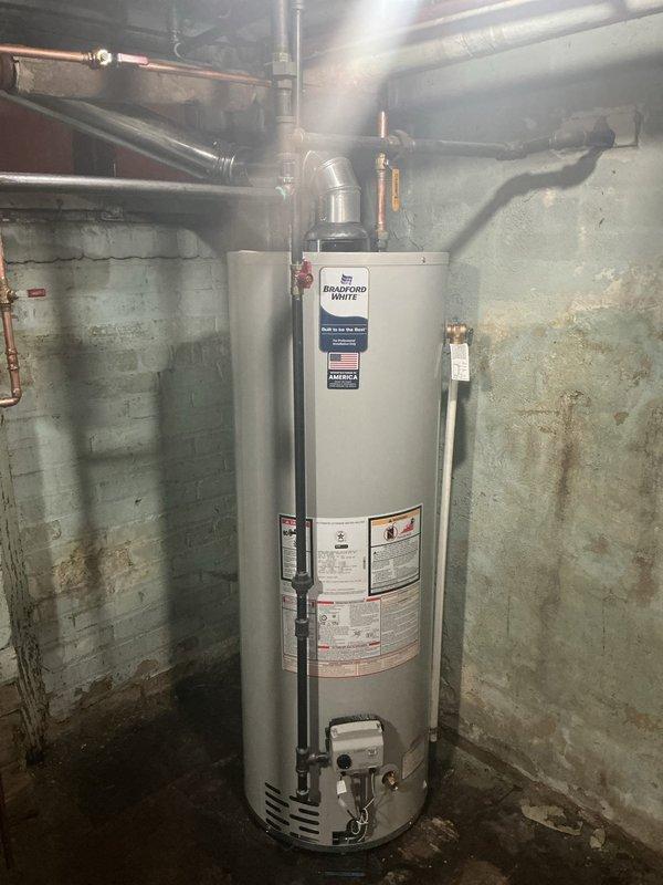 Completed full installation of new CG80C boiler system with thermostat and Bradford White 40-gallon water heater in basement utility area. Installed all necessary piping connections, exhaust venting, electrical wiring, and safety controls per manufacturer specifications and code requirements. Permit was obtained and all required documentation processed for final approval.