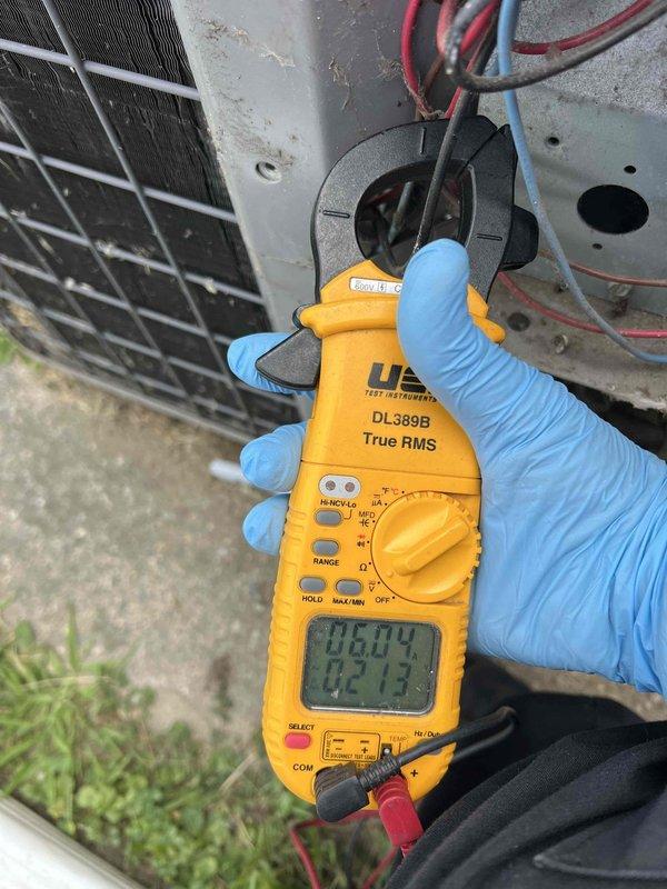 Responded to no-cooling complaint on 10+ year old air conditioning system. Upon arrival, confirmed outdoor condensing unit was not operating and system was blowing warm air indoors. Performed electrical diagnostics at outdoor unit using clamp meter to measure voltage and amperage at contactor and compressor connections. Identified electrical fault preventing compressor operation. Tested power supply, capacitor values, and contactor functionality to isolate failure point in outdoor unit's electrical system.