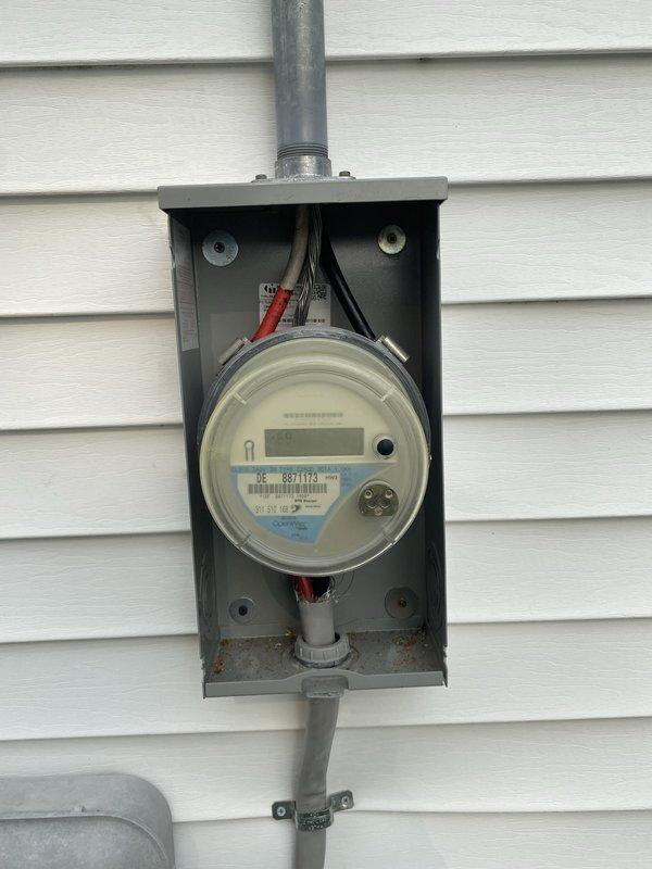 Performed comprehensive whole home electrical inspection for homeowner. Evaluated exterior electrical meter installation, noting functional digital meter with proper conduit connections, though enclosure showed age-related rust and corrosion requiring monitoring. Identified multiple extension cords improperly stored at ground level near foundation, creating potential safety hazards and code concerns that were documented for homeowner awareness and remediation.