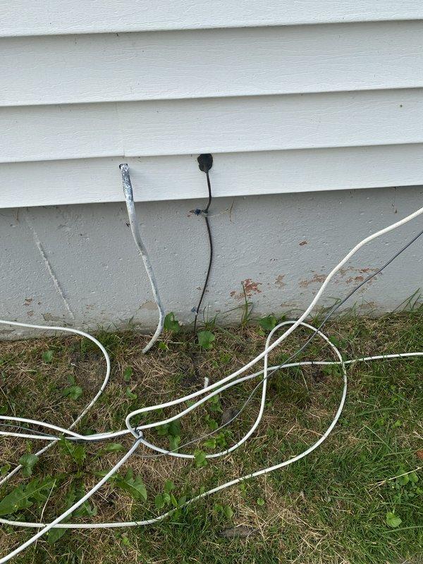 Performed comprehensive whole home electrical inspection for homeowner. Evaluated exterior electrical meter installation, noting functional digital meter with proper conduit connections, though enclosure showed age-related rust and corrosion requiring monitoring. Identified multiple extension cords improperly stored at ground level near foundation, creating potential safety hazards and code concerns that were documented for homeowner awareness and remediation.