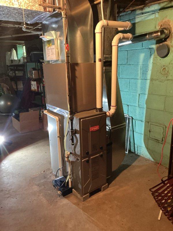 Completed comprehensive Gold AC inspection on 4-year-old air conditioning system located in basement mechanical room. Performed full system evaluation including visual inspection of HVAC unit, ductwork connections, refrigerant lines, and electrical components. Verified thermostat operation and programming functionality on Emerson programmable unit, confirming proper temperature control and system communication. Inspected condensate drainage, air handler components, and all accessible mechanical connections. System found to be operating within normal parameters with no immediate service needs identified. All equipment components visually assessed and documented through photographic records showing furnace assembly, copper refrigerant piping, ductwork, and control systems in satisfactory working condition.