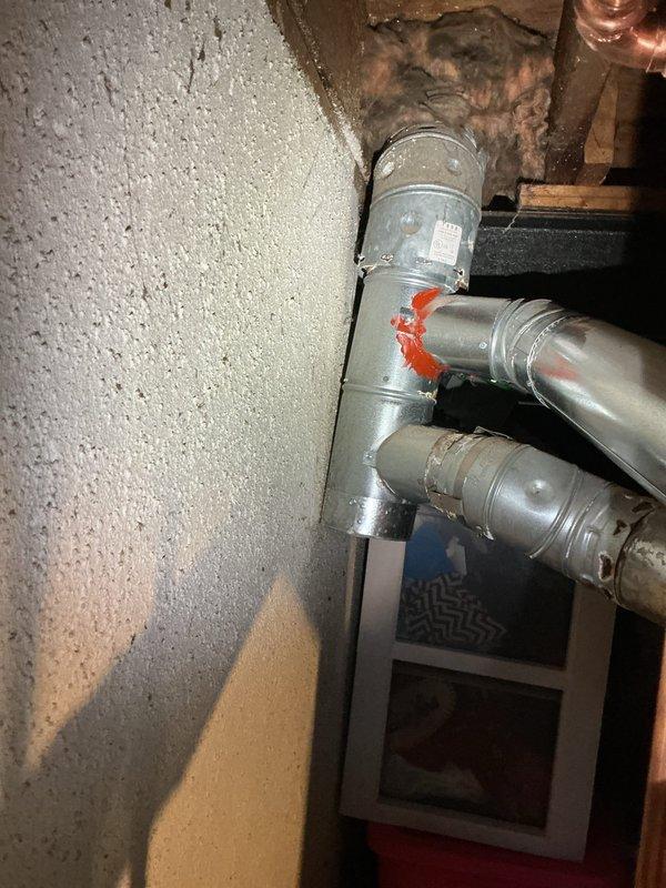 # Tanked Water Heater Service

Responded to a violation correction notice requiring installation of a B-vent T fitting on the water heater exhaust system. Upon arrival, inspected the existing galvanized vent piping configuration and identified the missing B-vent tee component required to bring the installation into compliance with current plumbing and venting codes.

Installed the proper B-vent T fitting into the existing vertical vent pipe system, ensuring secure connections between the water heater flue outlet and the main chimney vent. The B-vent T provides the necessary draft diverter and allows for proper venting of combustion gases while preventing downdrafts. Verified all connections were properly sealed and secured using appropriate fasteners and support brackets.

Confirmed adequate clearances from combustible materials and verified proper pipe support throughout the vertical run. Inspected surrounding copper water supply lines with shut-off valves and insulated piping to ensu